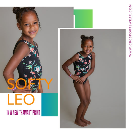 Girl wearing a Hawaii print Softy tank-style gymnastics leotard by cbcsportswear. Features a vibrant floral design, crafted from premium double brushed knit fabric for maximum softness and comfort. Ideal for young gymnasts with sensitive skin, ensuring seamless performance with encased seams.