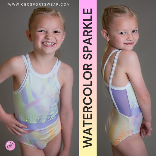 Watercolor Sparkle gymnastics leotard for girls by CBC Sportswear. Featuring a vibrant summery watercolor design with sparkly accents. Made from soft, double brushed knit fabric, perfect for sensitive skin. Ideal for young gymnasts seeking comfort and style.