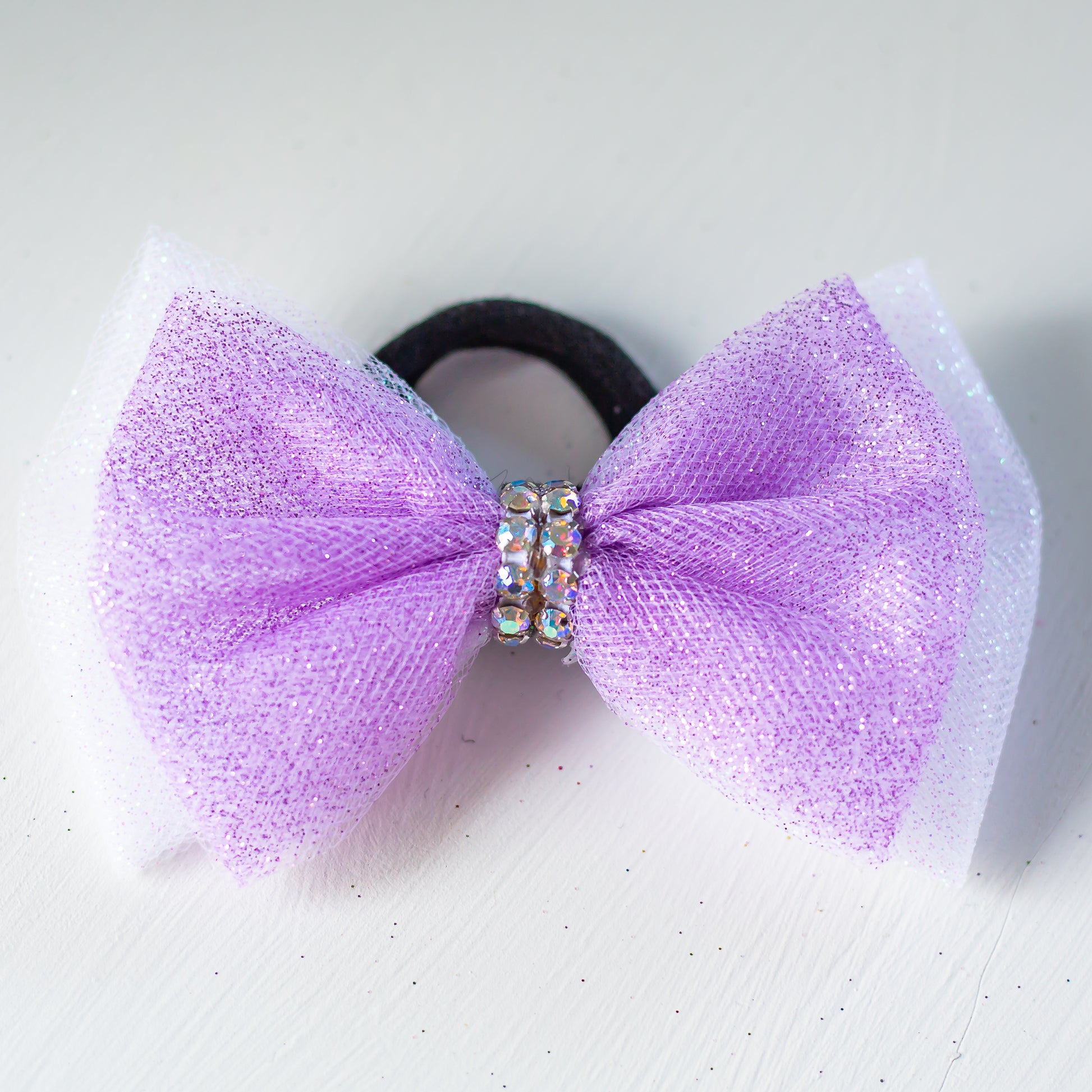 Rhinestone-wrapped gymnastics hair bow on hair tie, cbcsportswear