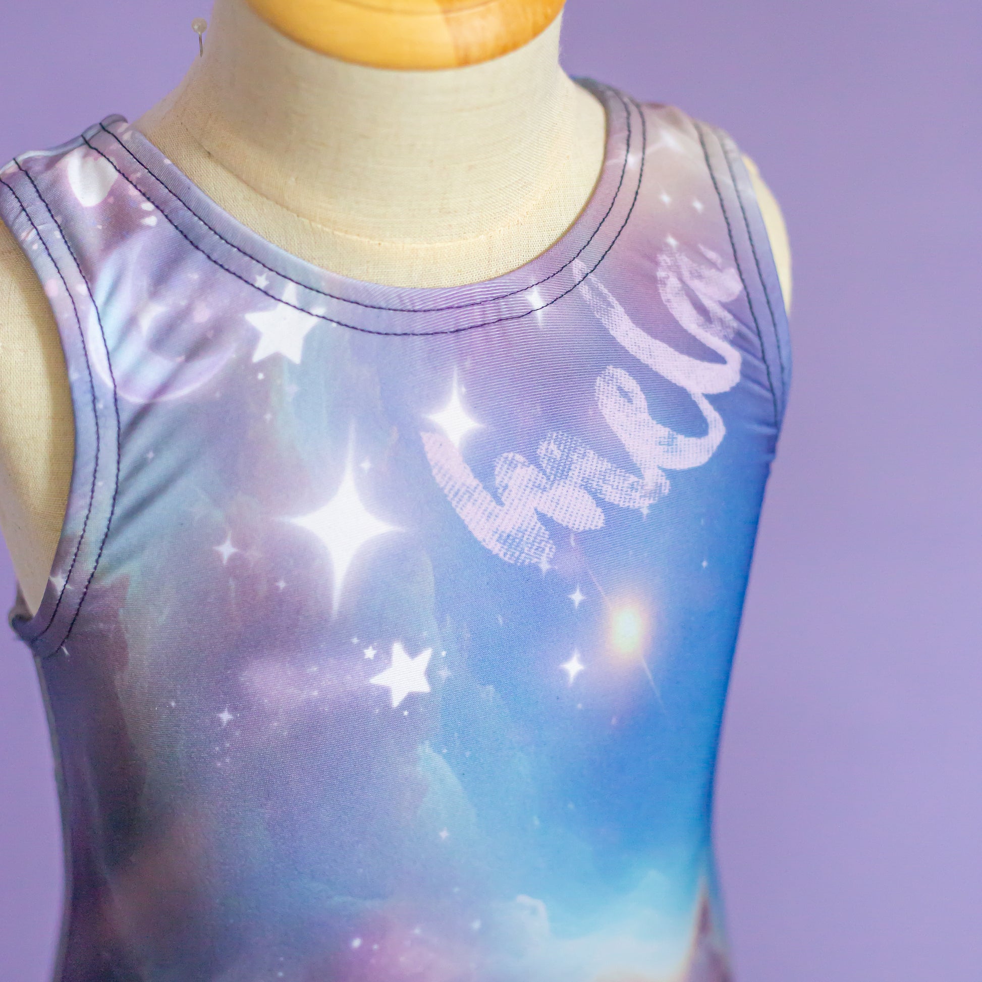 Personalized name sublimated into celestial galaxy leotard neckline, cbcsportswear