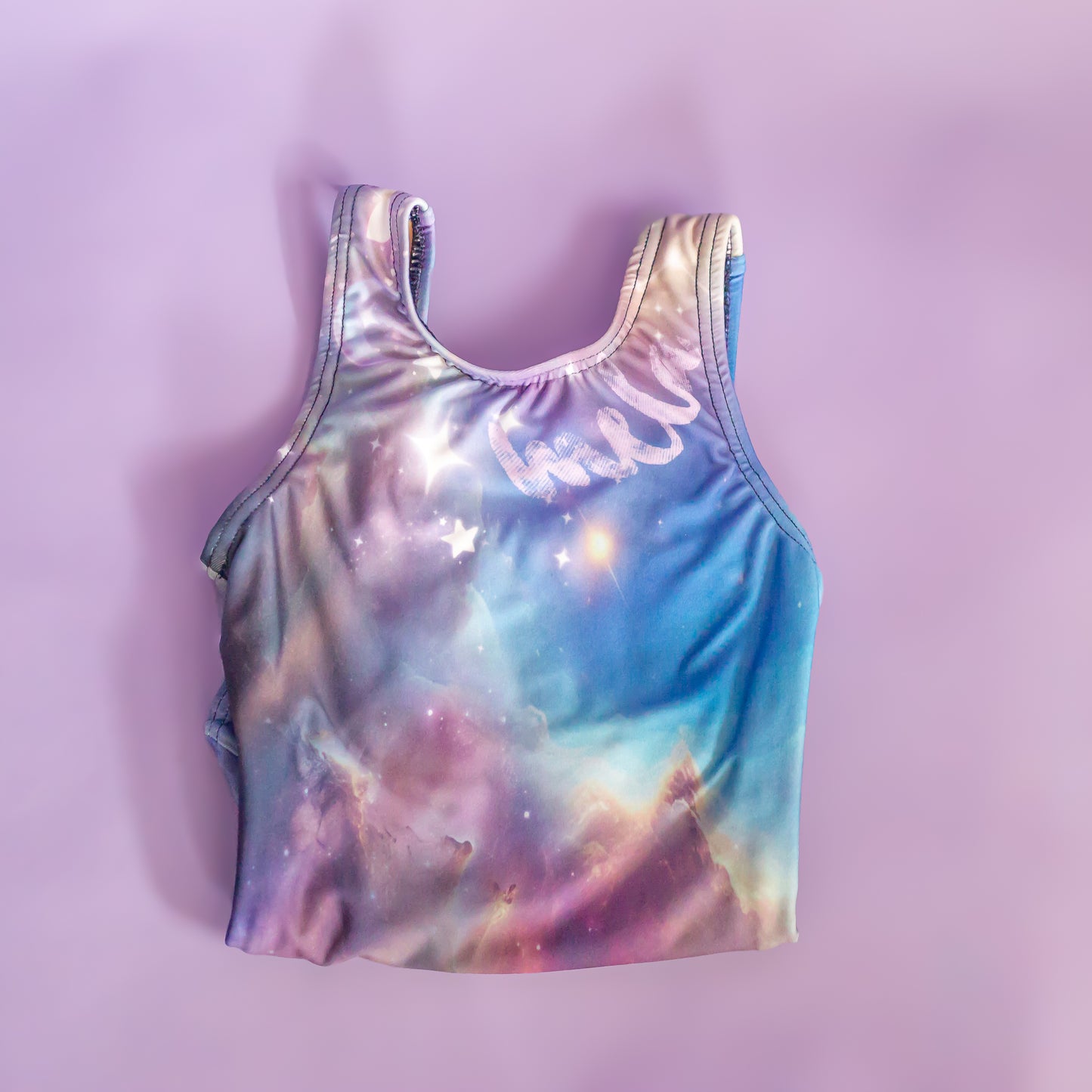 Celestial galaxy personalized leotard, folded flat lay, cbcsportswear