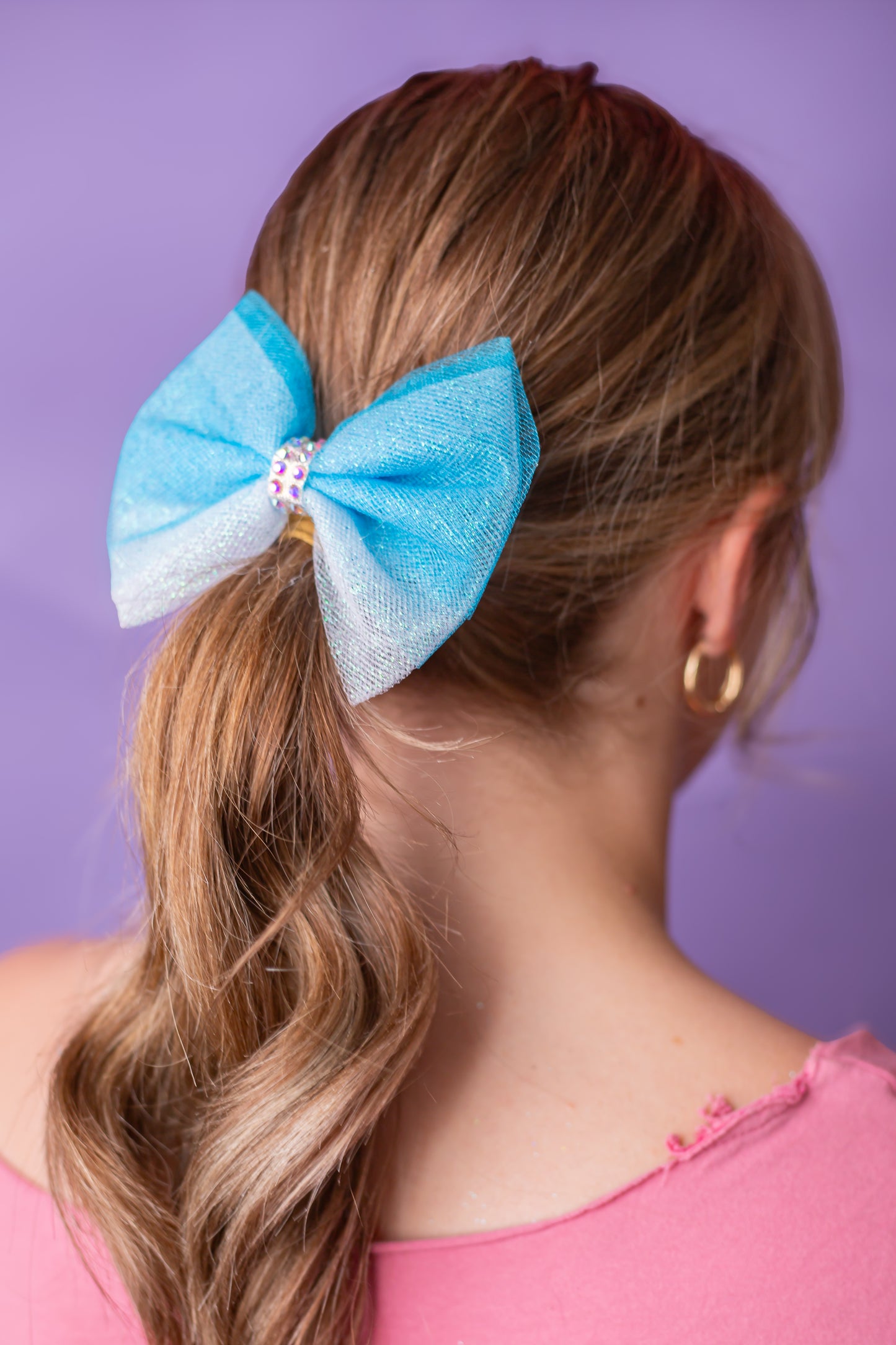 Ombre rhinestone gymnastics hair bow worn in a child's hair, cbcsportswear