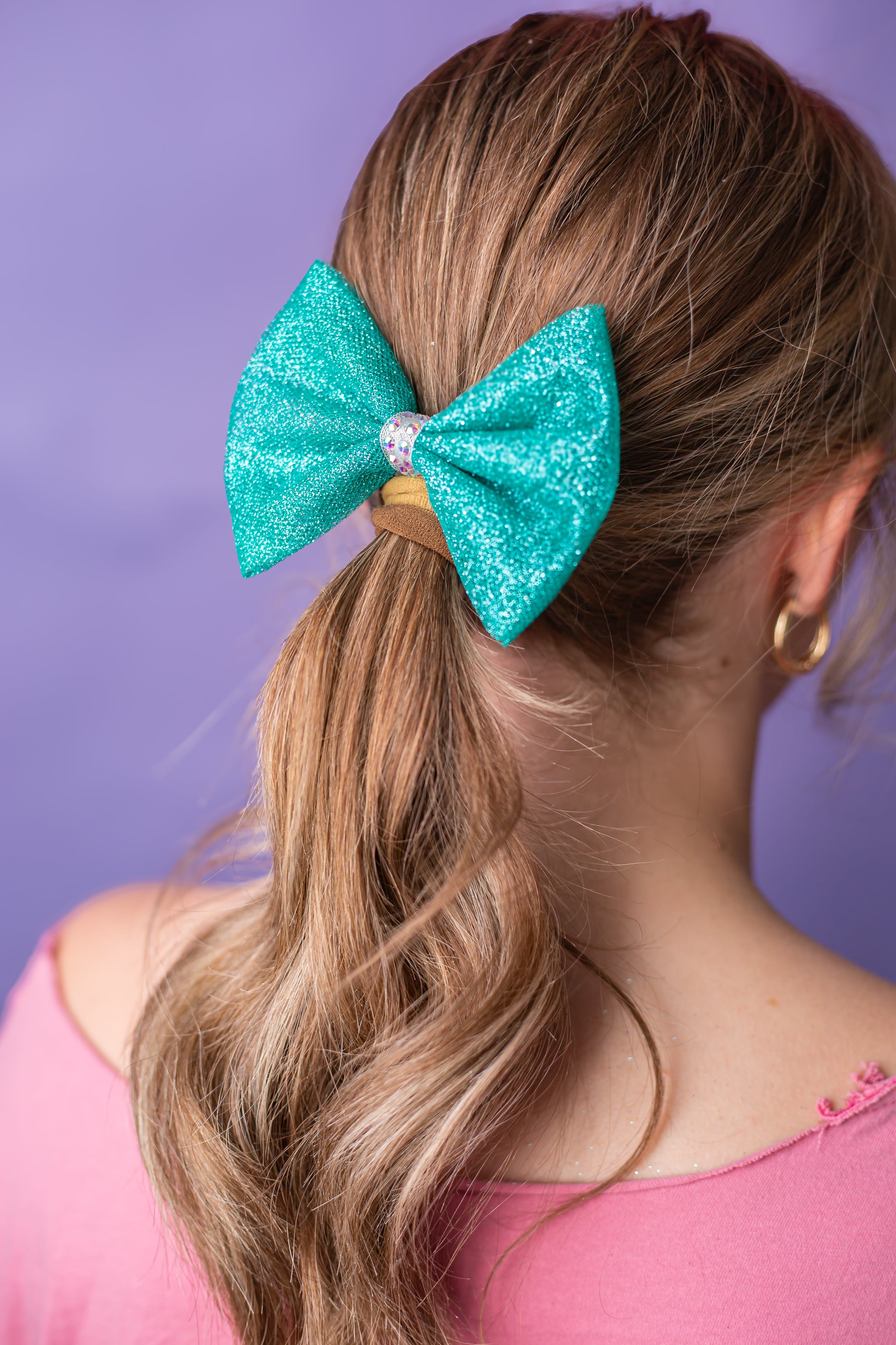Glitter tulle rhinestone gymnastics hair bow worn in a child's hair, cbcsportswear